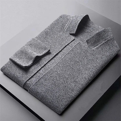 Zijaanzicht van de man in het grijze cardigan, die de soepele valling en moderne stijl benadrukt.