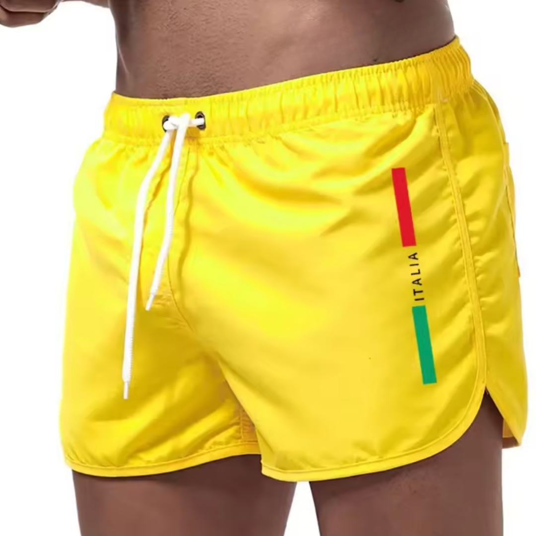 Drie Otis Italiaanse zwemshorts in verschillende kleuren (groen, geel, roze) naast elkaar, om de variëteit te tonen.
