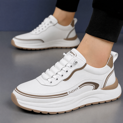 Een paar Aris leren sneakers in verschillende kleuren (zwart, bruin, wit) naast elkaar, tonend de variëteit.
